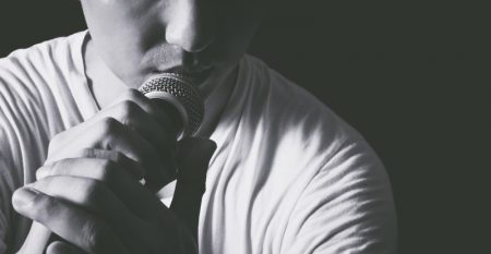 emotion portrait of asian male singer holding microphone, bw filter & isolated on black emotion portrait of asian male singer holding microphone, bw filter & isolated on black