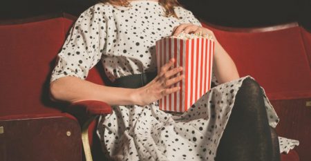 Young woman on front row of movie theater Young woman on front row of movie theater